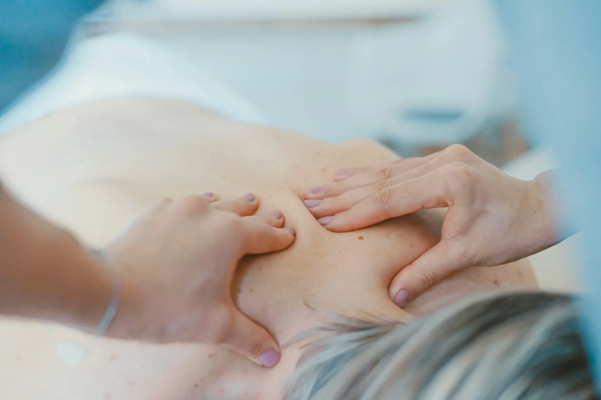 A massage therapist working on a client’s back