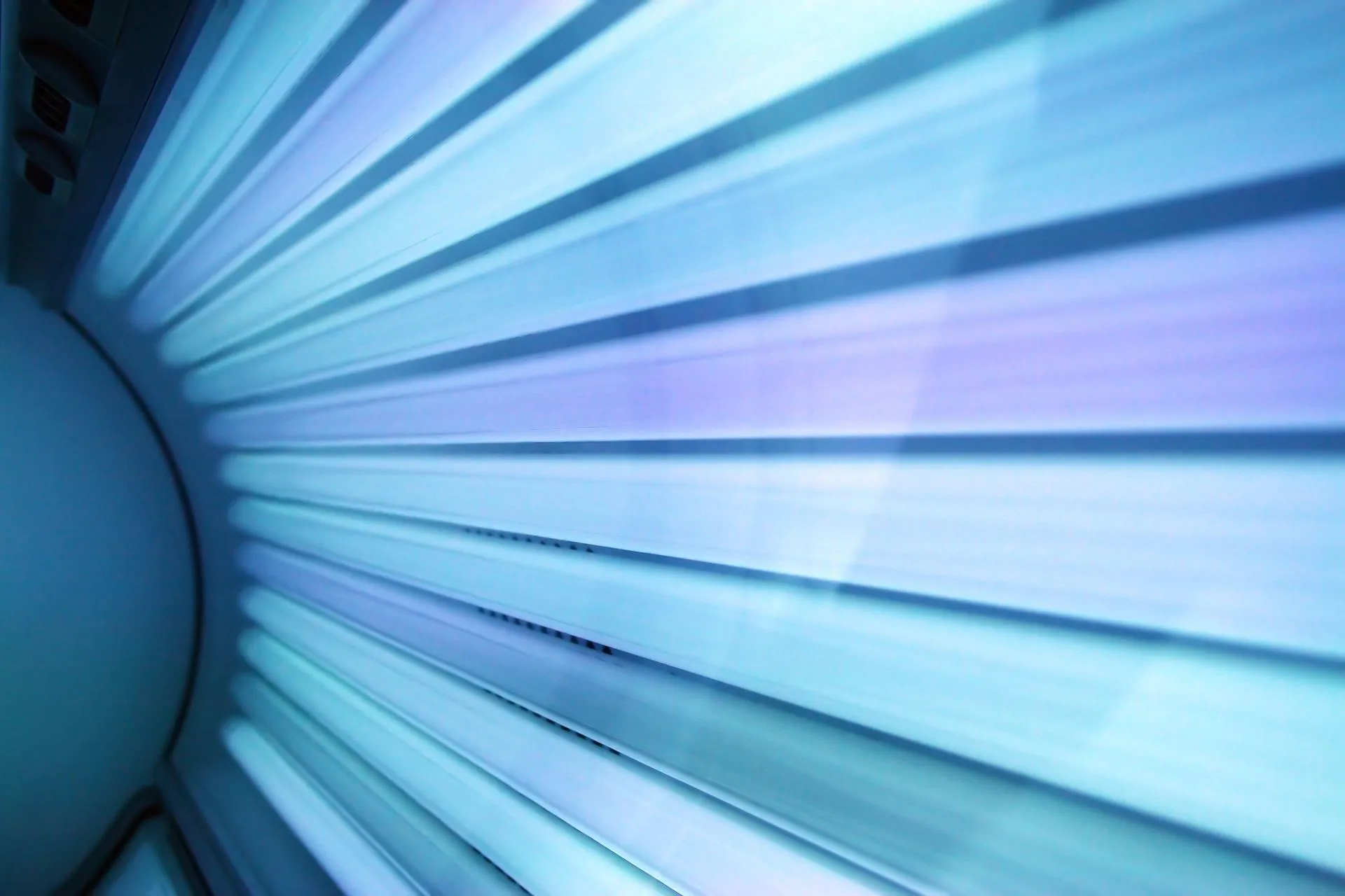 The lit lamp array inside a tanning bed, seen from the bed itself